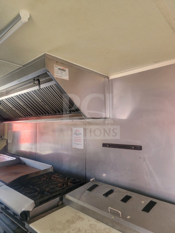 Rock Solid Cargo 8.5' x 24' mobile ghost kitchen trailer interior, featuring American Range fry line and ventilation hood.
