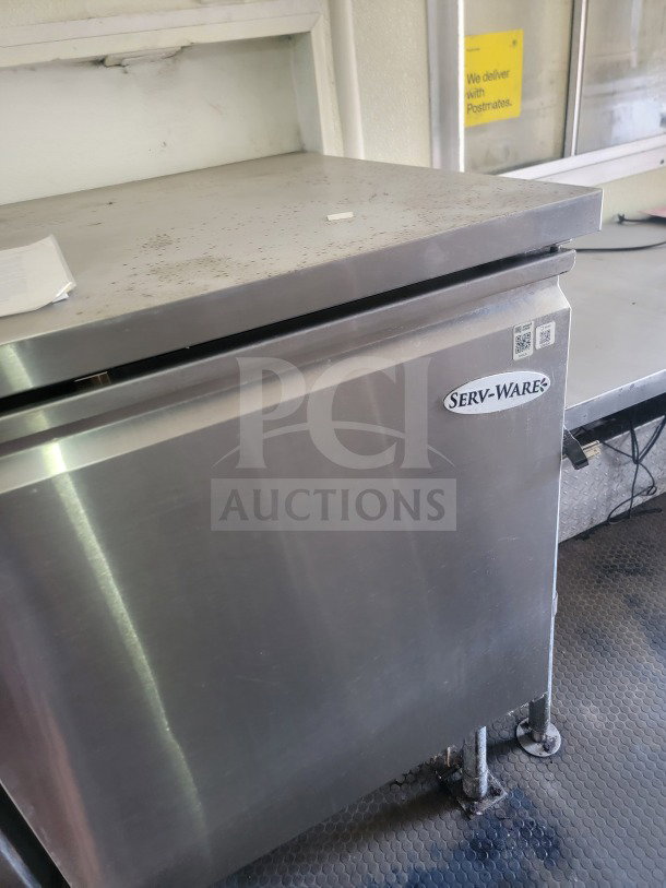 2021 Rock Solid Cargo 8.5' x 24' mobile kitchen trailer interior, featuring a Serv-Ware refrigeration unit.