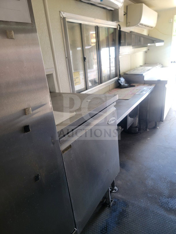 2021 Rock Solid Cargo 8.5' x 24' mobile ghost kitchen trailer interior with Serv-Ware refrigeration, stainless surfaces.
