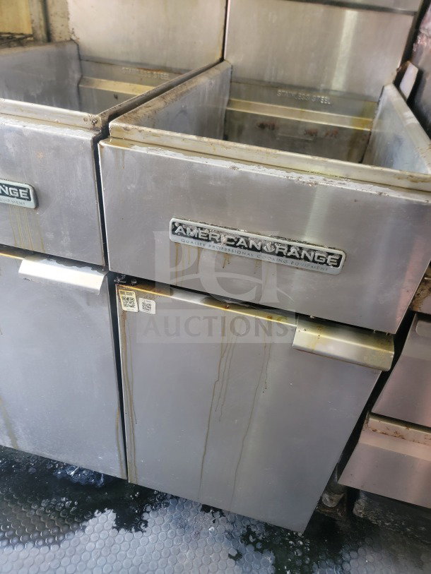 American Range stainless steel cooker in used condition from Rock Solid Cargo mobile kitchen trailer. Visible wear and labels.