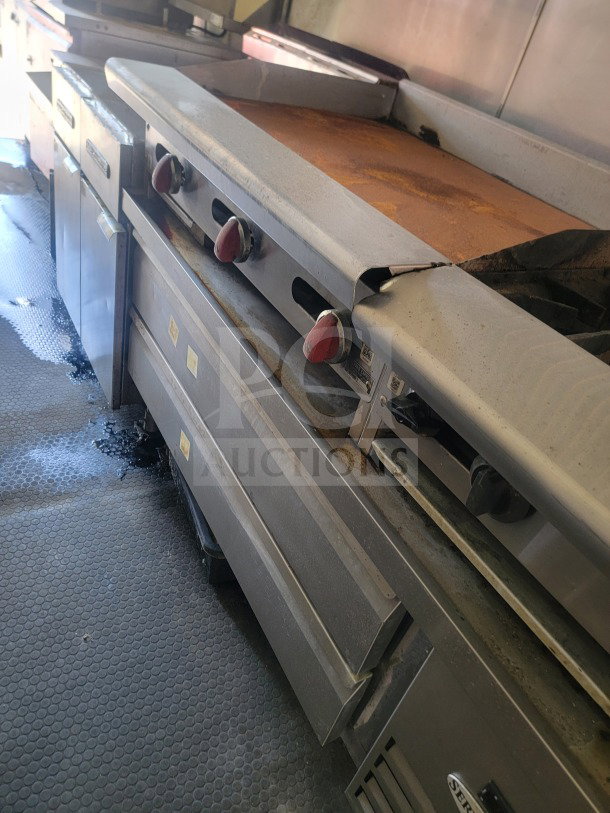 Rock Solid Cargo mobile ghost kitchen trailer interior showing Serv-Ware refrigeration and American Range fry line, used condition.