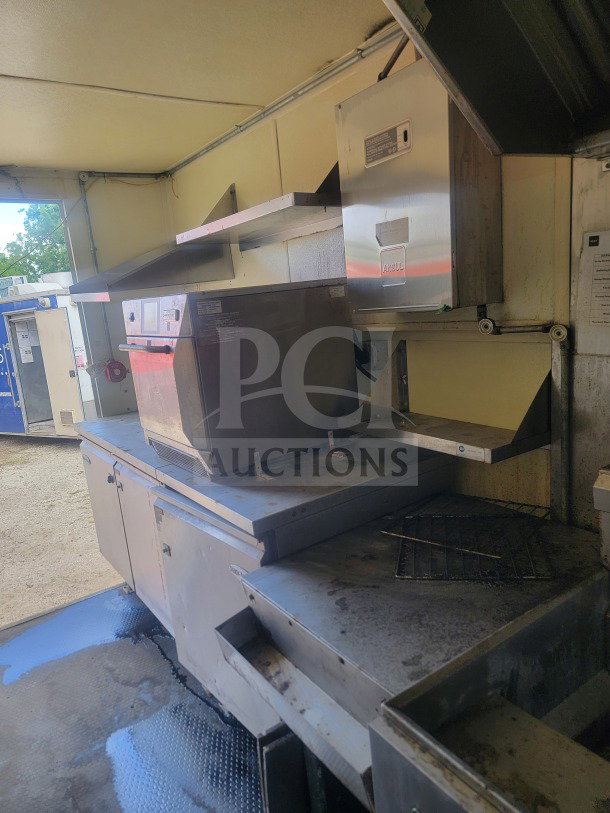 2021 Rock Solid Cargo 8.5' x 24' mobile ghost kitchen trailer interior, featuring Serv-Ware refrigeration and American Range fry line.