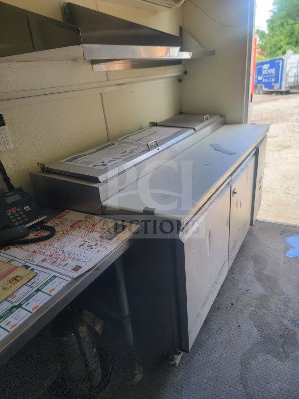 2021 Rock Solid Cargo 8.5' x 24' mobile ghost kitchen trailer interior, featuring stainless steel counters and equipment.