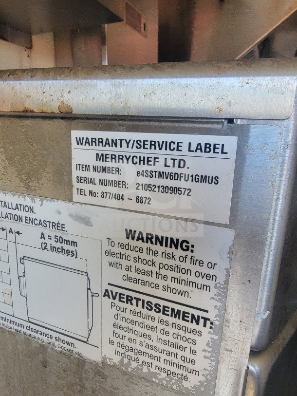 Warranty/service label on Merrychef appliance, item and serial numbers, warning for fire/electric shock risk with clearance info.