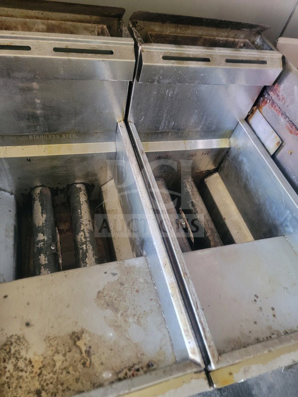 Stainless steel fryers inside 2021 Rock Solid Cargo mobile kitchen trailer, showing visible wear and residue.