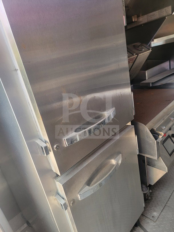 2021 Titanium Cargo 8.5' x 24' QSR Kitchen Trailer interior showing stainless steel cold storage units with True & Randell branding.