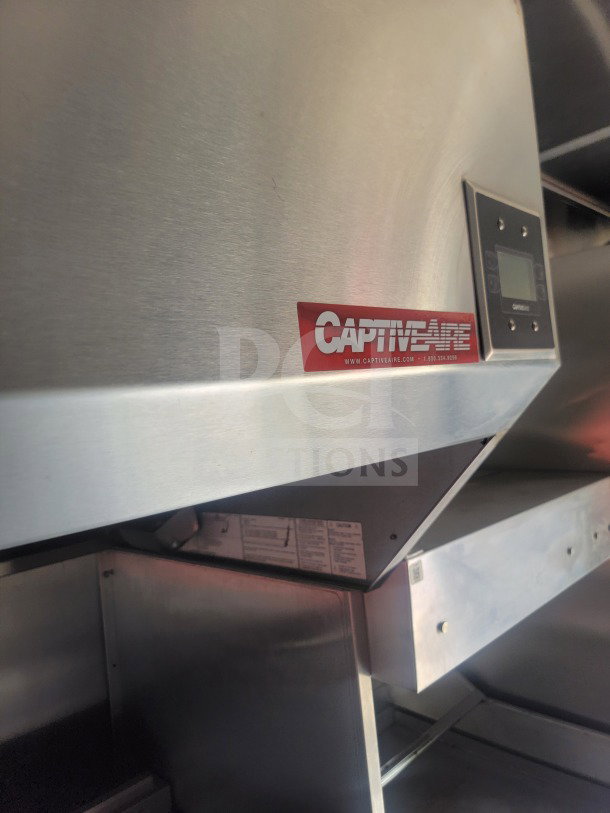 CaptiveAire ventilation system inside Titanium Cargo mobile kitchen trailer, featuring digital controls and stainless steel design.