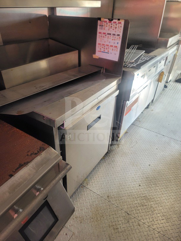 2021 Titanium Cargo 8.5' x 24' QSR kitchen trailer interior, featuring commercial-grade equipment and CaptiveAire ventilation.