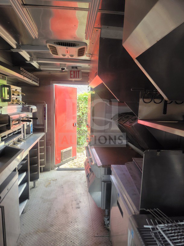 Interior of 2021 Titanium Cargo 8.5' x 24' QSR kitchen trailer, featuring CaptiveAire ventilation and cold infrastructure.