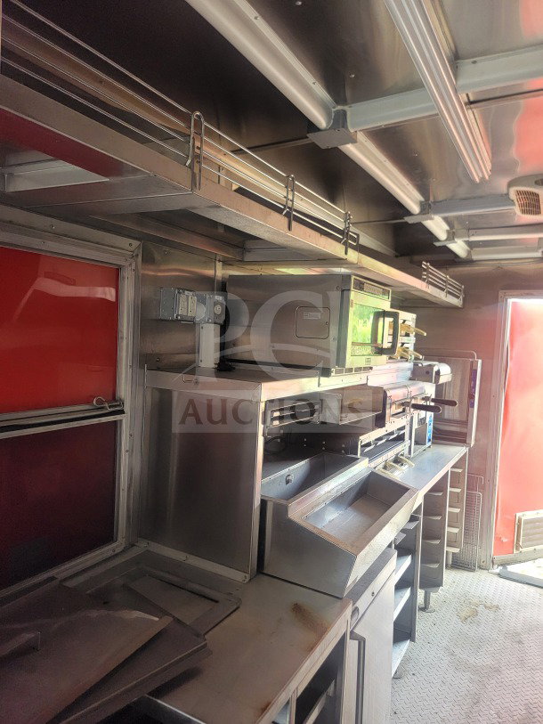 Interior of 2021 Titanium Cargo 8.5' x 24' mobile kitchen trailer; features CaptiveAire ventilation, True & Randell cold infrastructure.