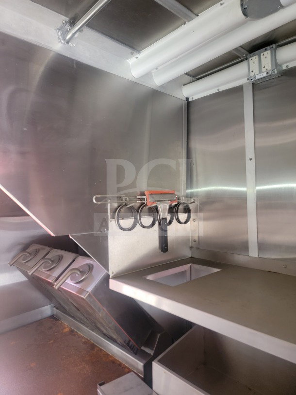 Interior of 2021 Titanium Cargo 8.5' x 24' kitchen trailer. Features include CaptiveAire ventilation and stainless steel surfaces.