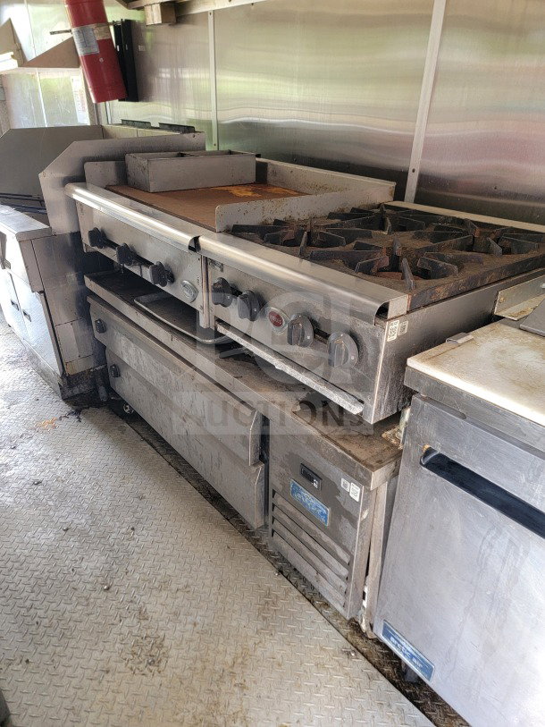 2019 Diamond Cargo 8.5' x 24' mobile kitchen trailer interior with Arctic Air storage, Wells cooking line, light wear visible.