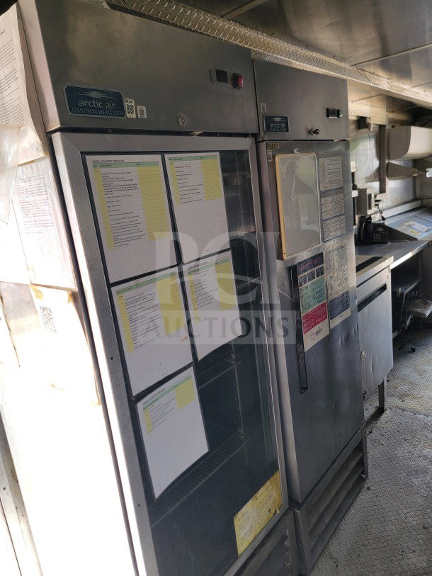 2019 Diamond Cargo mobile kitchen trailer interior with Arctic Air fridge, visible equipment checklist, and Wells cooking line.