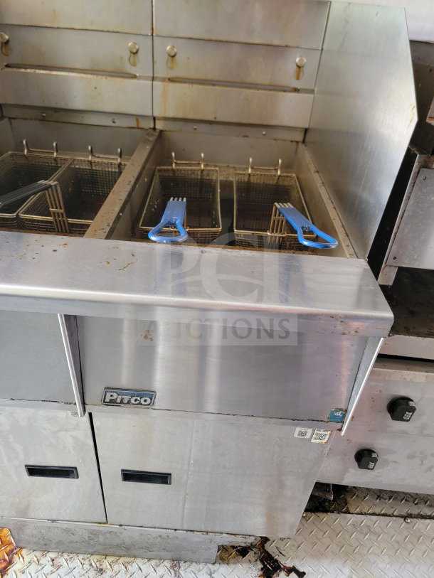 Pitco commercial fryer with dual baskets inside a 2019 Diamond Cargo mobile kitchen trailer, showing signs of use.