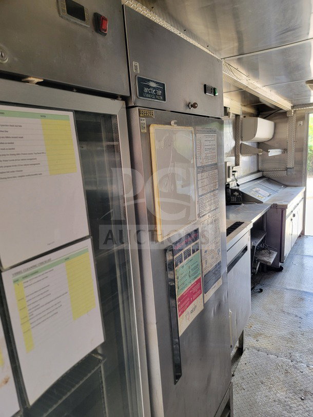 Diamond Cargo 8.5' x 24' mobile kitchen trailer interior, featuring an Arctic Air storage suite and Wells cooking line.