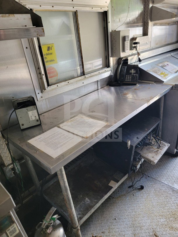 2019 Diamond Cargo 8.5' x 24' Mobile Kitchen Trailer interior, featuring a stainless steel workstation, telephones, and equipment storage.