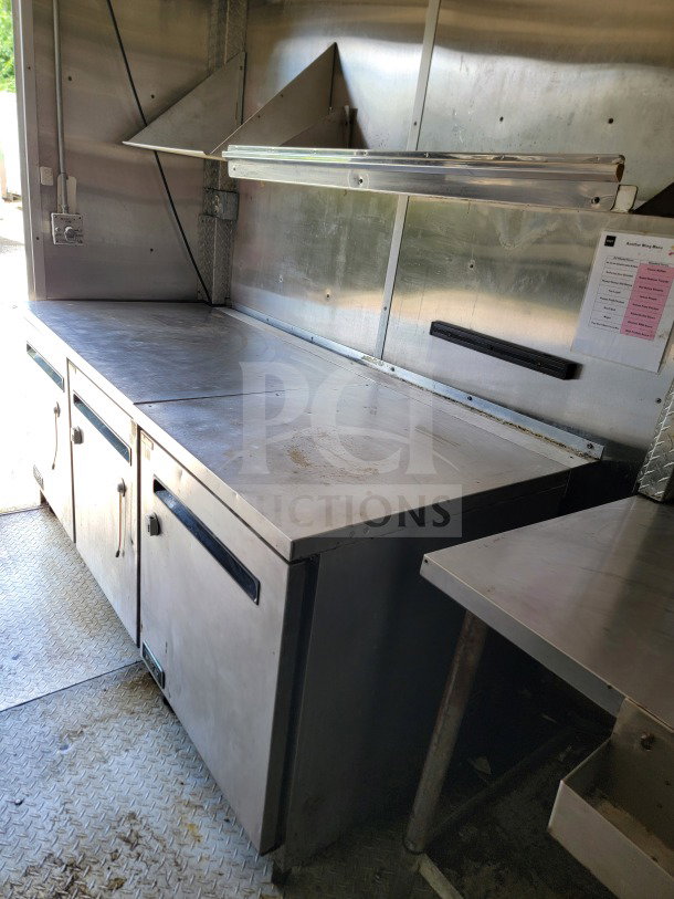 2019 Diamond Cargo 8.5' x 24' mobile kitchen trailer interior with stainless steel prep station and Arctic Air storage.
