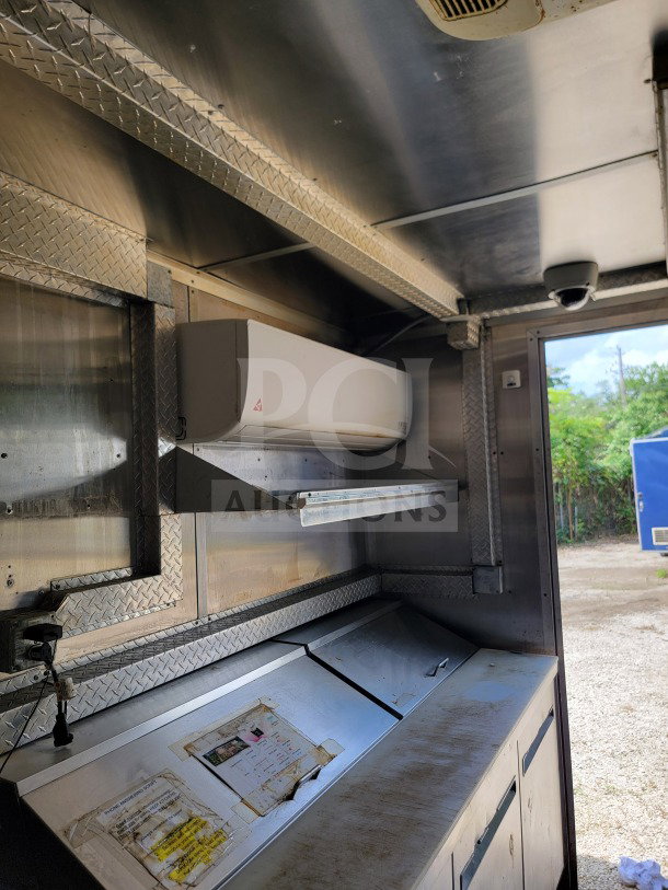 2019 Diamond Cargo 8.5' x 24' mobile kitchen trailer interior, showing Arctic Air storage and Wells cooking line. Excellent condition.