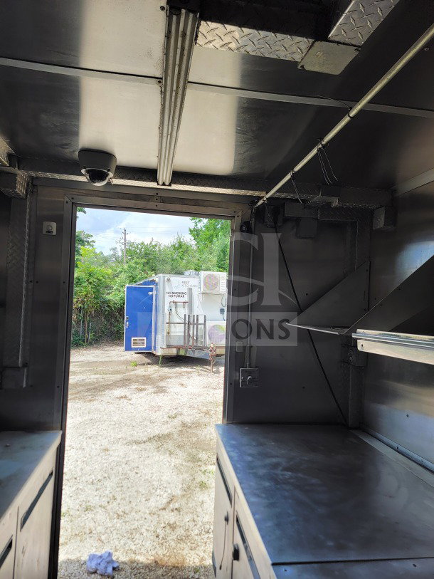 Interior view of 2019 Diamond Cargo 8.5' x 24' mobile kitchen trailer, featuring stainless steel countertops and wiring.