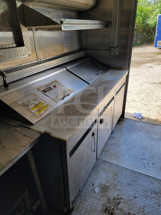 2019 Diamond Cargo 8.5' x 24' mobile kitchen trailer interior with storage and prep area, moderate wear.