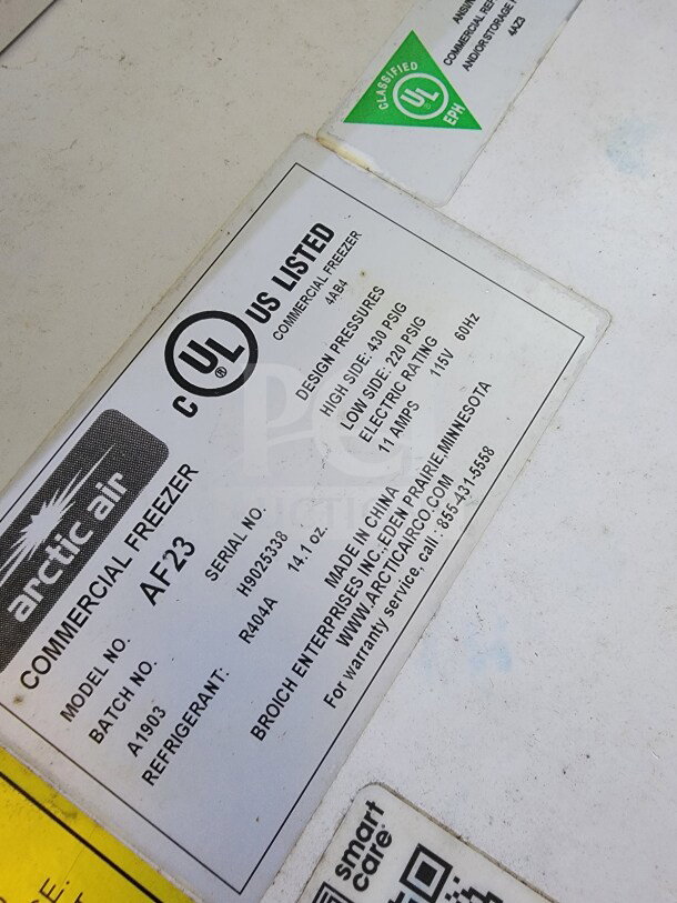 Label on Arctic Air AF23 commercial freezer showing model, serial number, and UL listing for the mobile kitchen trailer.