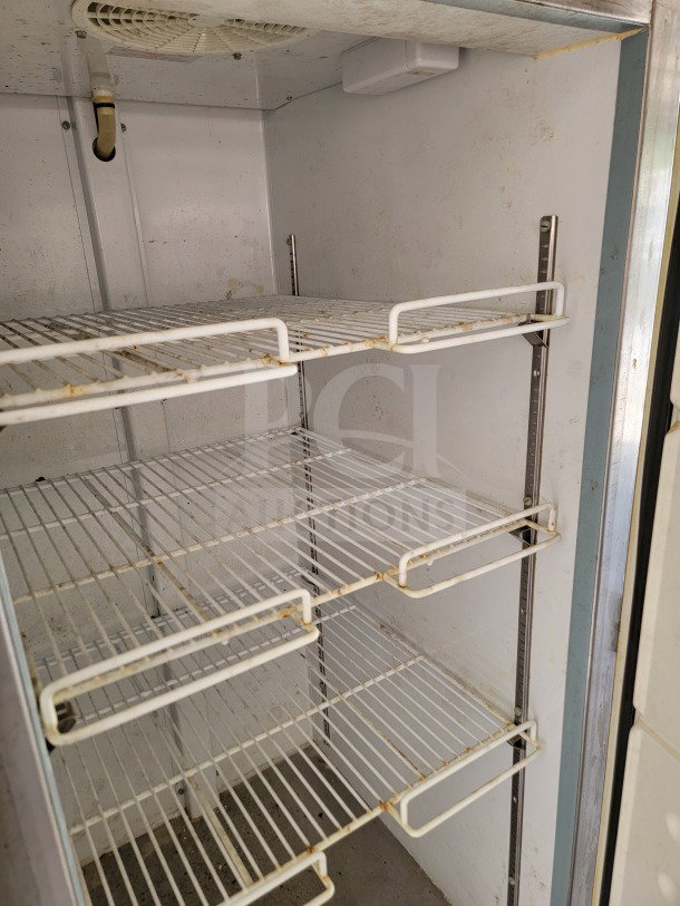 Interior view of Arctic Air storage suite in 2019 Diamond Cargo trailer. Features wire shelving, moderate wear visible.