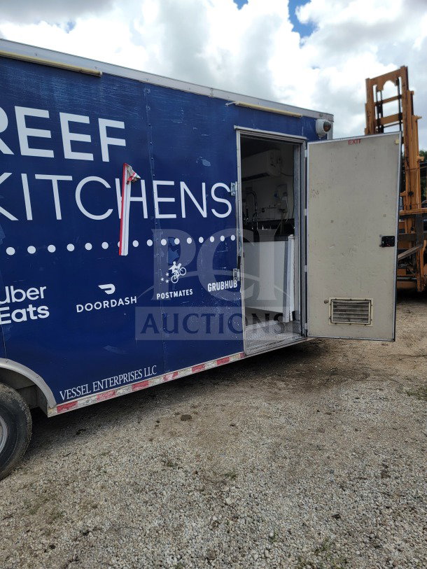 2019 Diamond Cargo 8.5' x 24' mobile kitchen trailer, blue exterior, open door, partial kitchen view, branded decals.