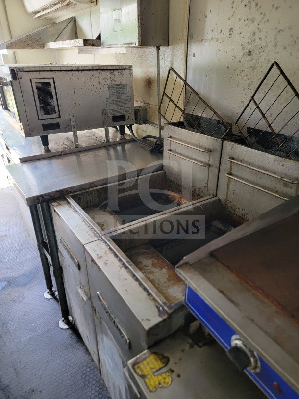 2019 Diamond Cargo 8.5' x 24' mobile kitchen trailer interior with American Range fry line and Globe Electric griddle. Used condition.