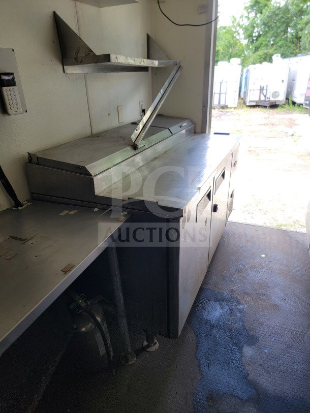 2019 Diamond Cargo 8.5' x 24' mobile kitchen trailer interior with stainless steel countertop and shelves.
