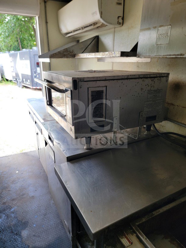 2019 Diamond Cargo mobile kitchen trailer interior, featuring a Globe Electric griddle and stainless steel counters.