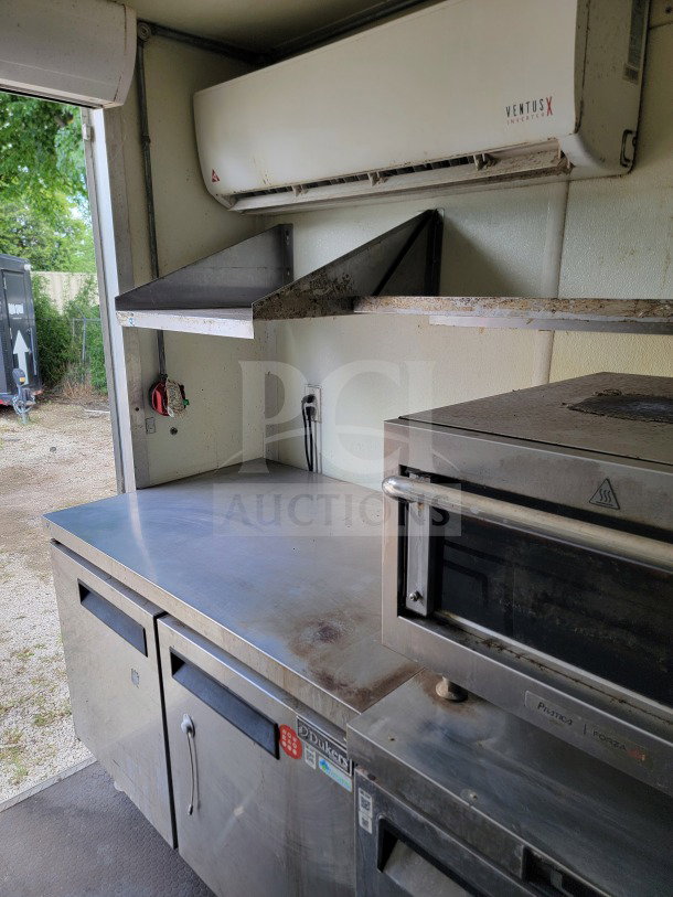 2019 Diamond Cargo 8.5' x 24' mobile kitchen trailer interior, featuring stainless steel countertops, shelving, and a Dukers unit.