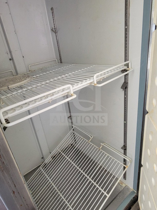 Diamond Cargo 8.5' x 24' mobile kitchen trailer interior; empty shelving, metal racks show light wear, suitable for ghost kitchen setup.