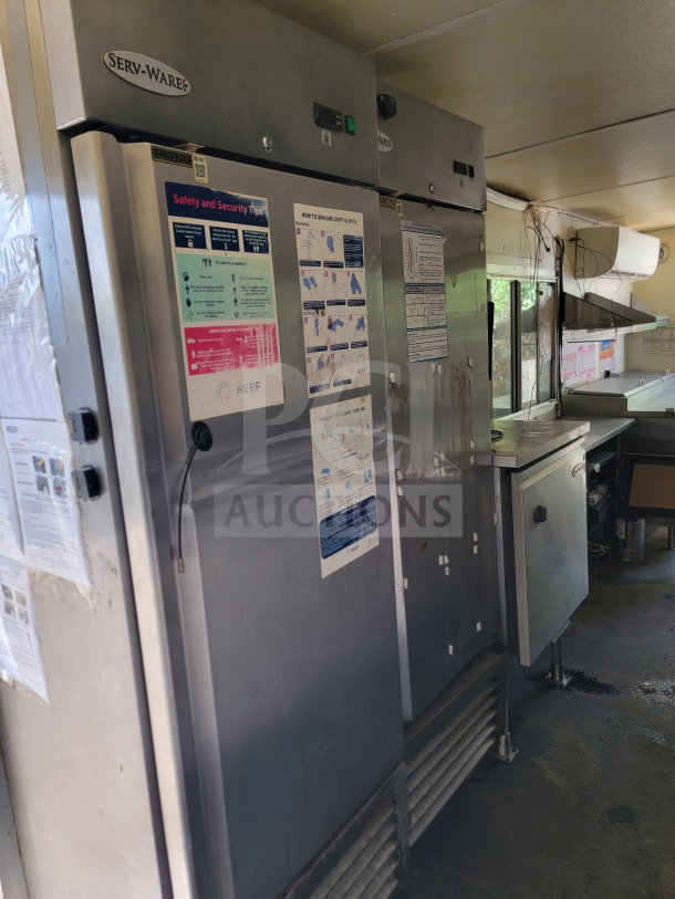 2019 Diamond Cargo 8.5' x 24' mobile kitchen interior, featuring Serv-Ware refrigeration units. Includes safety and security labels.