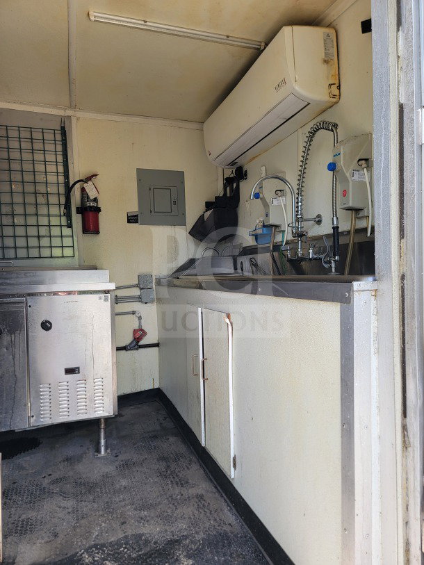 2019 Diamond Cargo 8.5' x 24' mobile kitchen trailer interior, featuring Serv-Ware setup, sink, refrigeration unit, and equipment.