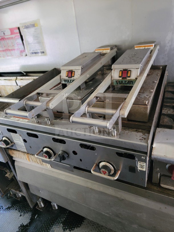 Vulcan cooking equipment inside a mobile kitchen trailer, featuring dual controls and a sturdy, stainless steel design.