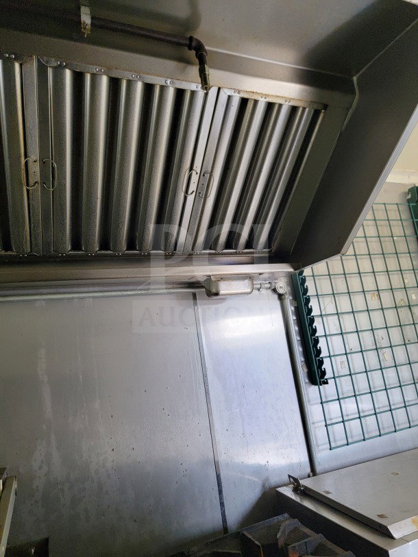 2019 Diamond Cargo mobile commercial kitchen trailer interior, showing stainless steel surfaces and overhead ventilation hood.