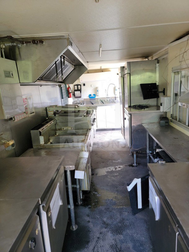 2019 Diamond Cargo 8.5' x 24' mobile kitchen trailer interior. Features Serv-Ware equipment, stainless steel surfaces, and hood.