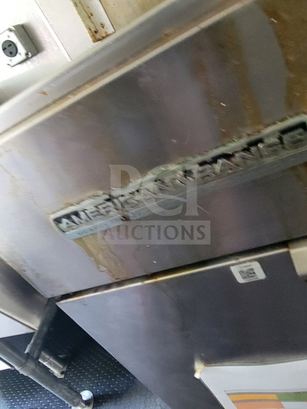 American Range appliance with visible rust and wear inside a 2019 Diamond Cargo mobile kitchen trailer.