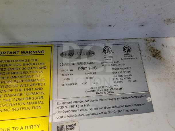 Label inside the trailer showing Serv-Ware commercial refrigerator model PP67-9-HC specifications and warning instructions.