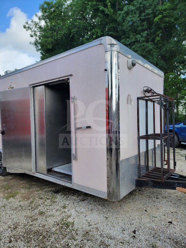 2021 Forest River 8.5' x 24' mobile kitchen trailer, tandem-axle, white, open door, VIN 5NHUNSZ25MY040811 visible.