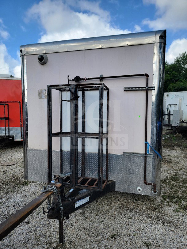 2021 Forest River 8.5' x 24' mobile kitchen trailer, tandem-axle, visible hitch, diamond plate siding, white exterior, good condition.