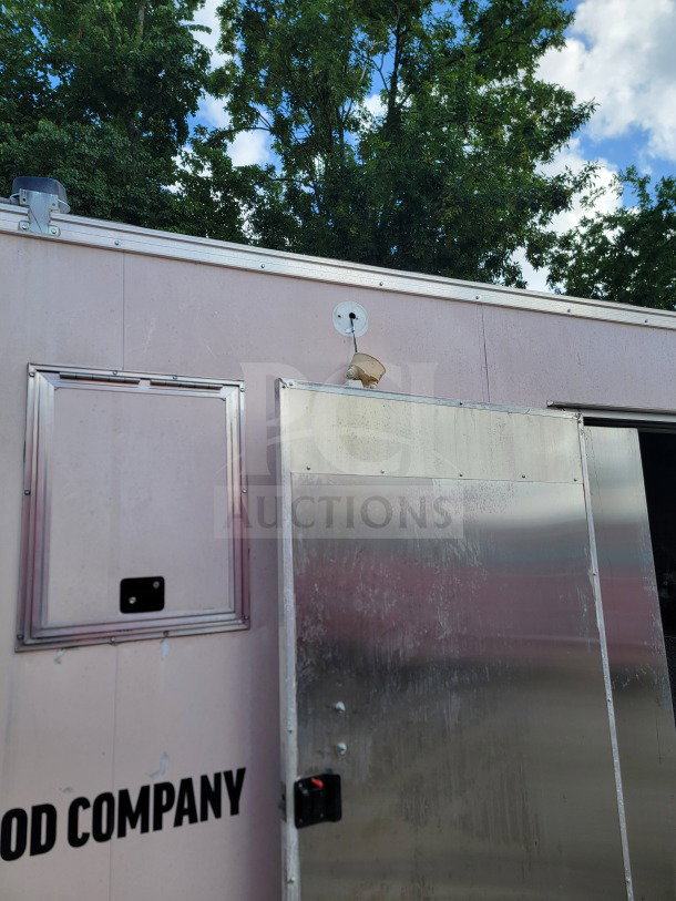 2021 Forest River 8.5' x 24' mobile kitchen trailer exterior, tandem-axle, aluminum doors, slight wear, VIN visible.