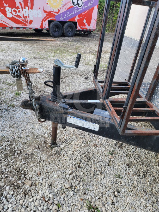 Trailer hitch of a 2021 Forest River 8.5' x 24' mobile kitchen. Visible VIN: 5NHUNSZ25MY040811. Slight rust on metal frame.