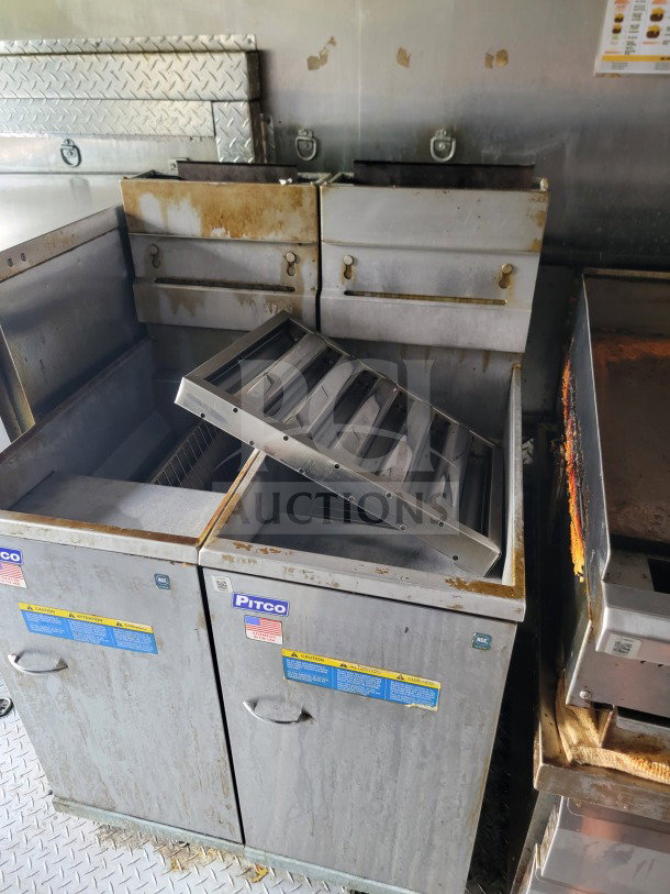 Forest River 2021 mobile kitchen trailer with Pitco fryers, visible wear and grease, Royal Range suite, Arctic Air refrigeration.