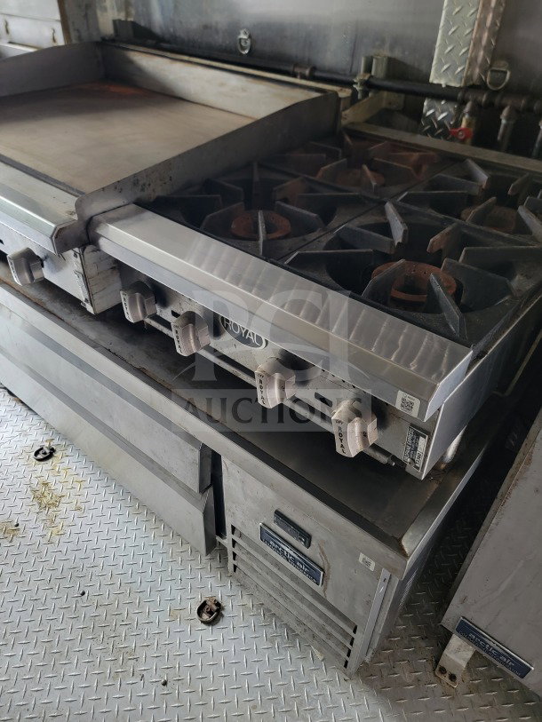 Forest River mobile kitchen trailer with Royal Range cooking suite and Arctic Air refrigeration. Features visible controls and metallic surfaces.