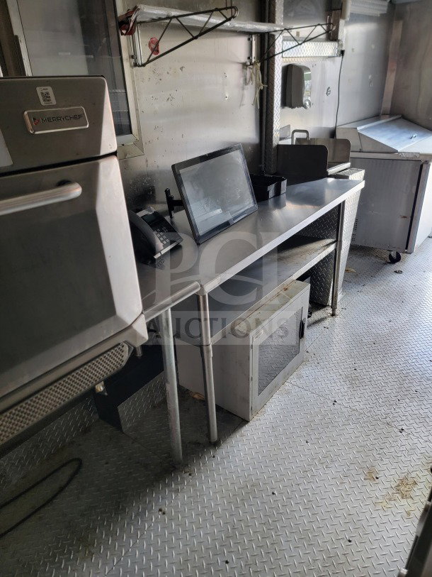 2021 Forest River 8.5' x 24' mobile kitchen trailer interior with stainless steel counters, Merrychef oven, and equipment slots.