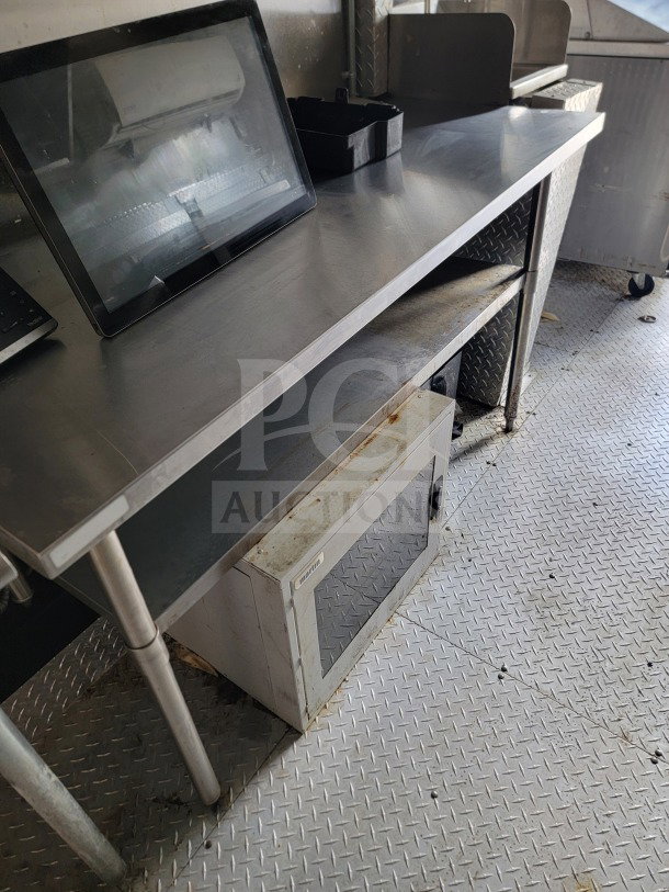 Forest River 8.5' x 24' kitchen trailer interior, stainless steel counter, microwave below, diamond plate flooring.