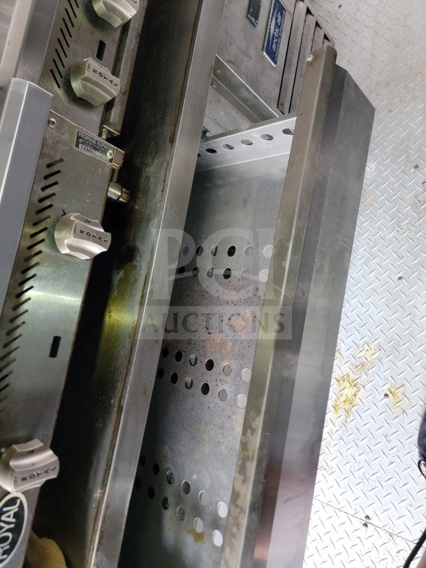 Royal Range control knobs on a mobile kitchen trailer equipped with Arctic Air refrigeration in the Forest River 24 model.