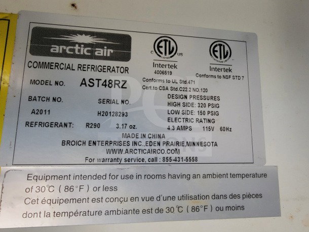 Commercial refrigerator label for Arctic Air model AST48RZ, includes refrigerant type and conditions. Made in China.