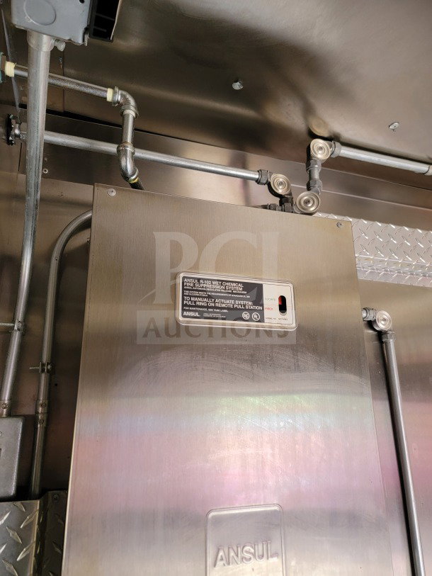 Forest River mobile kitchen trailer, internal Ansul R-102 wet chemical fire suppression system. Model info visible on panel.